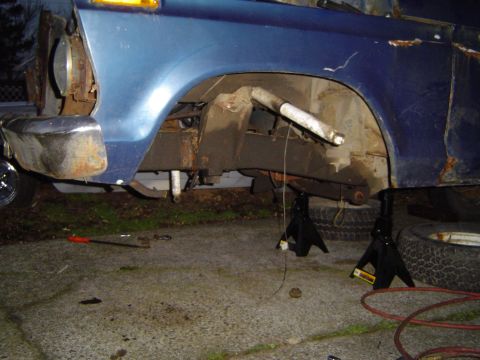 1979 Ford Bronco - Front suspension and wheel well of a 1979 Ford Bronco, supported by jack stands.