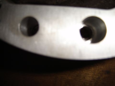 1992 Ford Bronco - A metal bracket with two holes is shown, with "SUPERMOTORS" visible at the bottom.