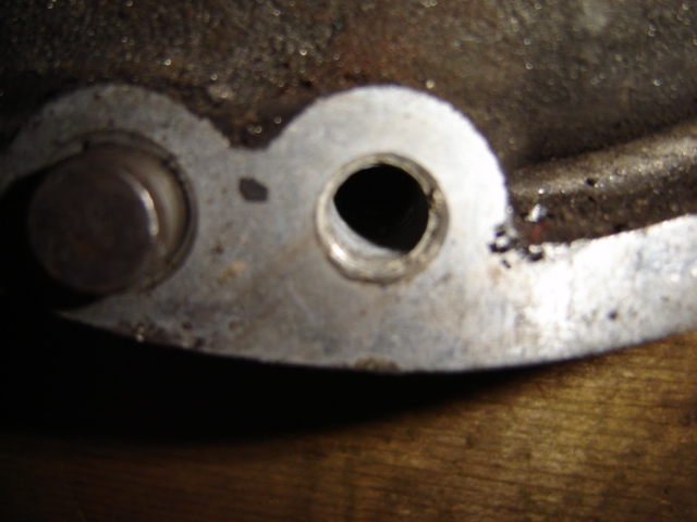 Close-up of a metal engine part with two holes