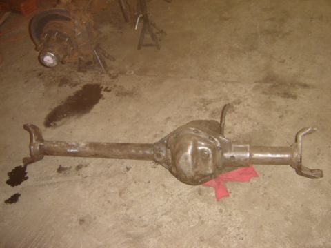 1992 Ford Bronco - A rear axle assembly is shown on a concrete floor, with a red rag placed beneath it.