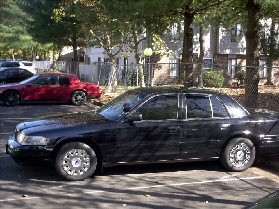 Black 2001 Ford Crown Victoria sedan, side view