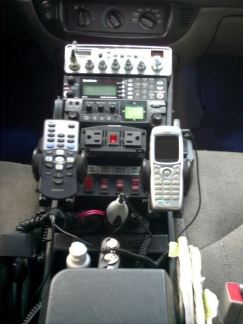 2001 Ford Crown Victoria - The center console of a vehicle is outfitted with communication and power equipment.