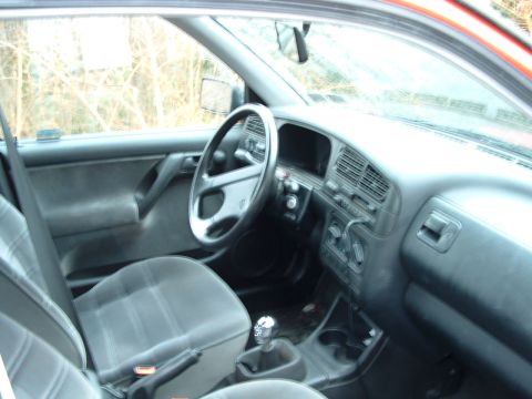 1994 Volkswagen Jetta - The interior of a car is shown, the dashboard, steering wheel, and front seats.