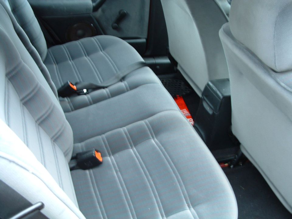 Gray cloth rear bench seat interior with subwoofer behind