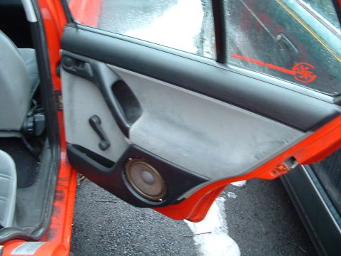 1994 Volkswagen Jetta - Car door interior with speaker and manual window crank.