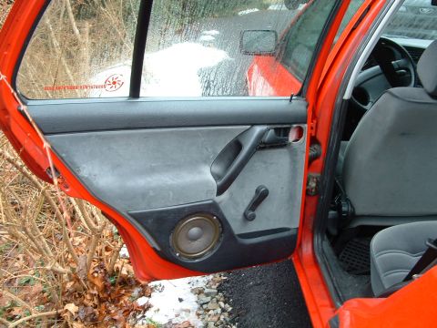 1994 Volkswagen Jetta - Interior view of a 1994 Volkswagen Jetta's driver's side door panel, showing the speaker and manual window crank.