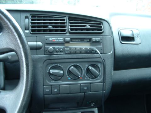 1994 Volkswagen Jetta - The interior of a car shows the dashboard with a Volkswagen radio and climate controls, suggesting a model year around 1993.