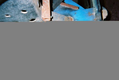 1983 Ford Bronco - Close-up view of rusted metal parts, some with blue paint.