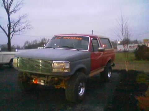 1989 Ford Bronco - This 1989 Ford Bronco is seen from a three-quarter front angle, showing its two-tone paint job and modified front end.