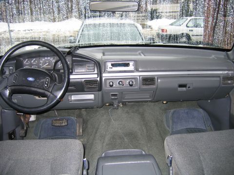 1992 Ford Bronco - Interior view of a 1992 Ford Bronco, with other vehicles seen through the windshield.