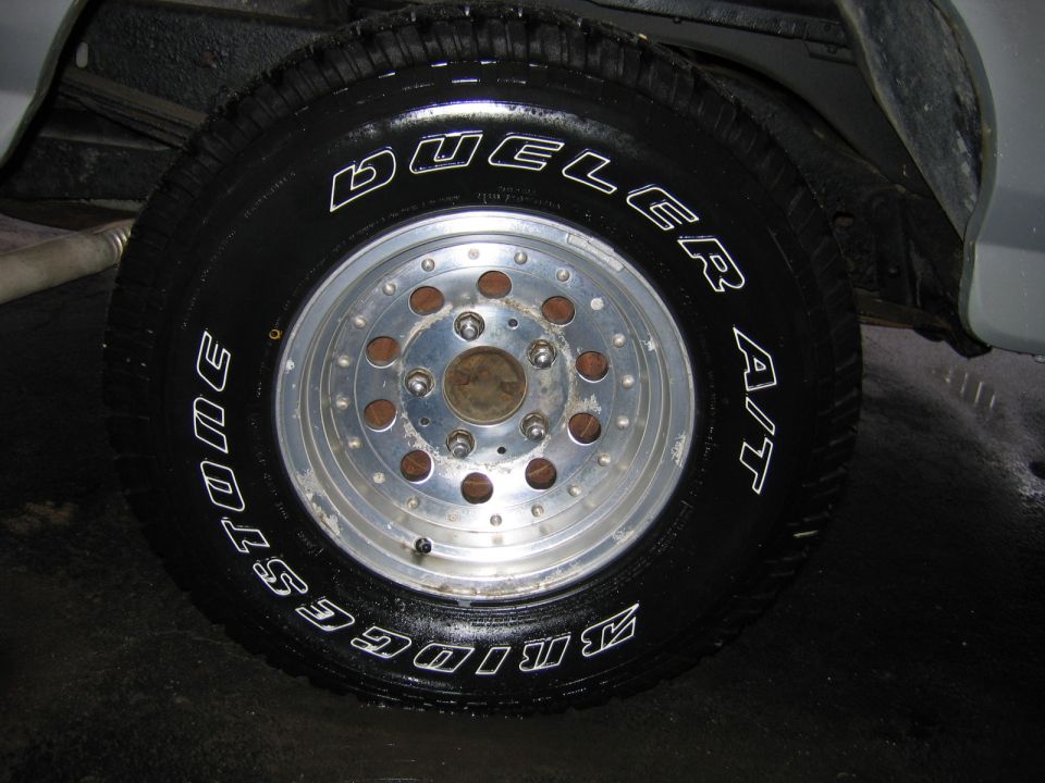 Bridgestone Dueler A/T tire on a multi-lug aluminum wheel