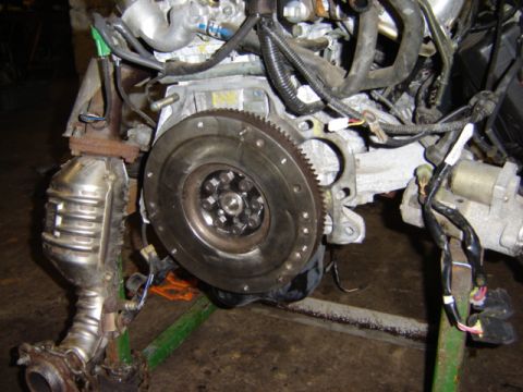 1992 Ford Bronco - Close-up of an engine assembly, showing the flywheel and exhaust components.