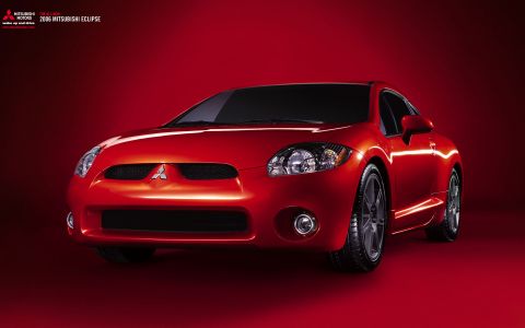 2000 Ford Mustang - A red 2006 Mitsubishi Eclipse is presented in a studio setting against a red background.