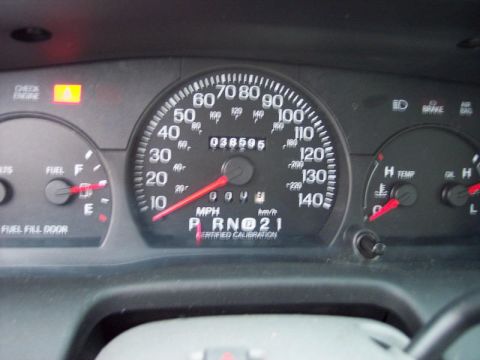 1999 Ford Crown Victoria - The dashboard shows the vehicle's mileage and various operational gauges, including speed and fuel level.