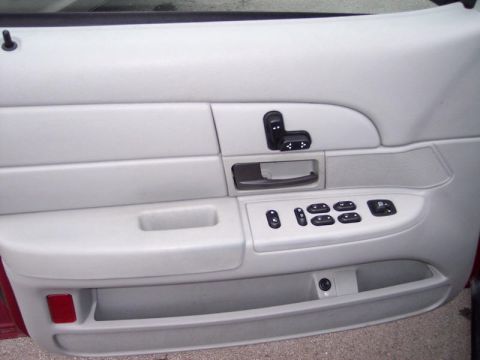 1999 Ford Crown Victoria - Interior view of a 1999 Ford Crown Victoria's driver's side door panel, showing the power window and lock controls.