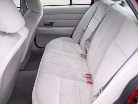 1999 Ford Crown Victoria - Interior view of a 1999 Ford Crown Victoria, focusing on the rear seating area.