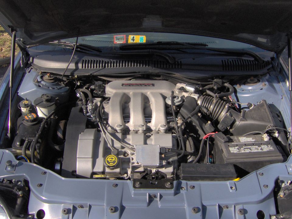 Clean engine bay of a Ford Taurus with Duratec 24-valve V6 intake manifold visible