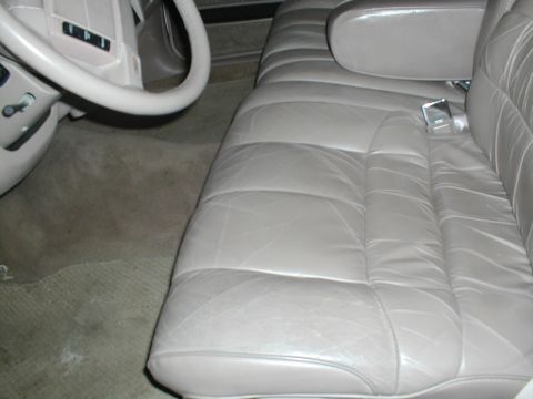 1979 Ford Bronco - The interior of a car shows plush leather seats and a steering wheel, with a watermark from Supermotors.net.