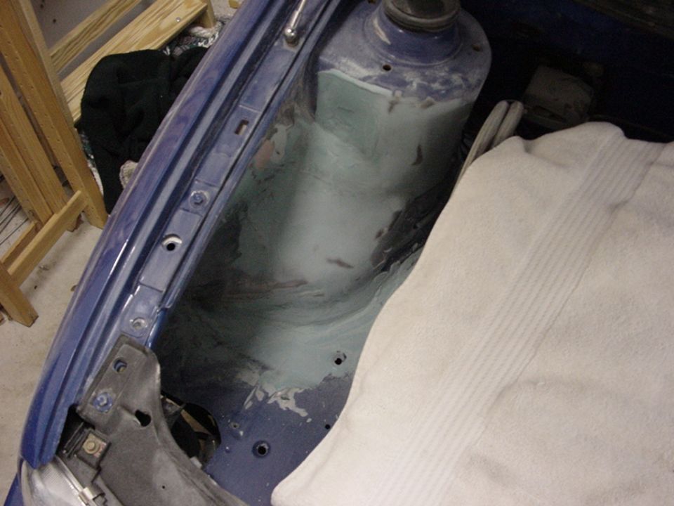 Blue 1998 Volkswagen Jetta engine bay strut tower with body filler