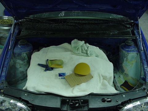1998 Volkswagen Jetta - Car engine bay prepared for work with tools and protective covering.