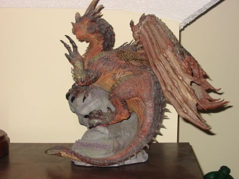 1991 Ford Bronco - A detailed dragon figurine is displayed on a rock base, with text visible on the rock.