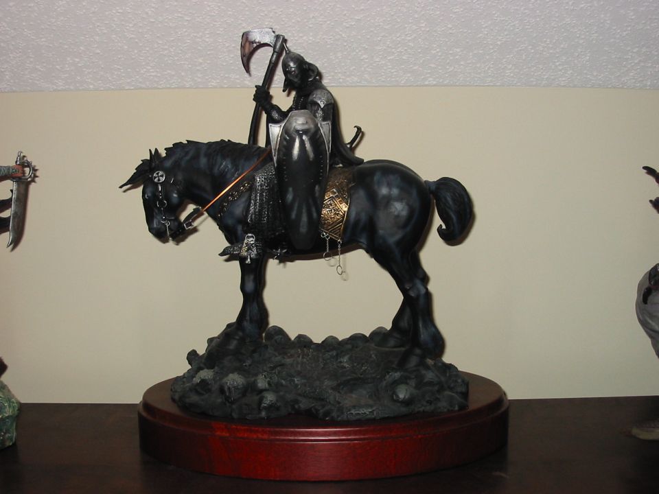 Grim reaper statue on black horse with scythe and shield