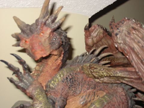 1991 Ford Bronco - A detailed dragon figurine is shown up close, with its head and claws prominently visible.
