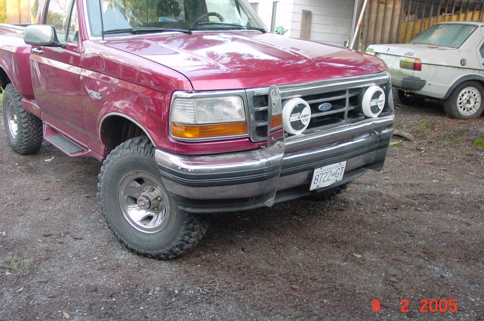Red 1992 Ford F-150 pickup truck front 3/4 view with auxiliary lights and license plate 8722-GT