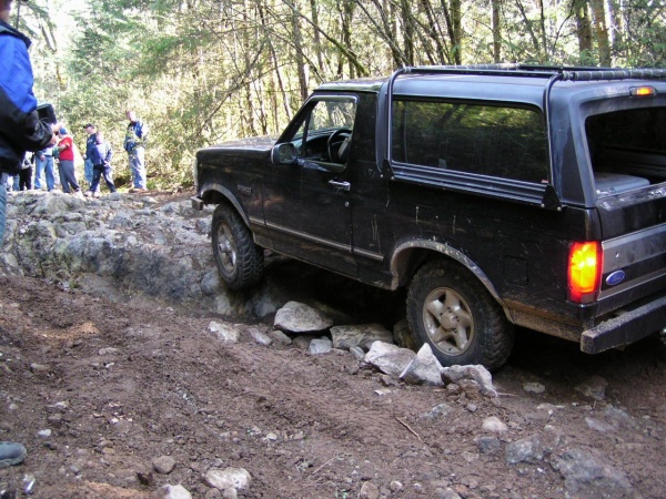 Black 1995 Ford Bronco navigating rocky terrain