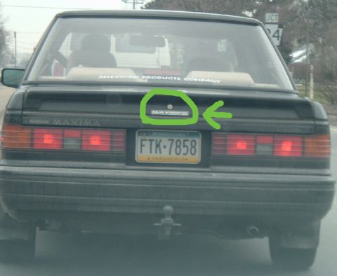1994 Ford Probe - Rear view of a Nissan Maxima, a "Police Interceptor" badge and Pennsylvania license plate FTK-7858.