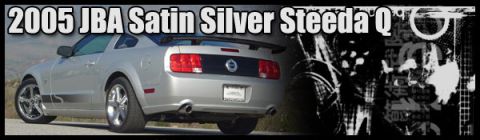 2000 Ford Mustang - Rear view of a silver 2005 Ford Mustang with custom wheels and a spoiler.