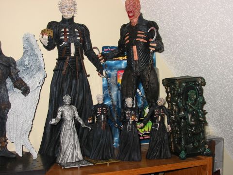 1991 Ford Bronco - Several Hellraiser action figures are displayed on a shelf, some in packaging.