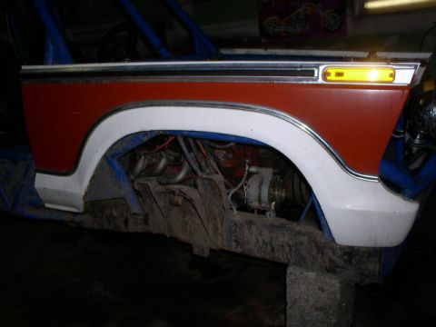 1979 Ford Bronco - This photo shows the fender and exposed engine of a vehicle, possibly undergoing modifications.