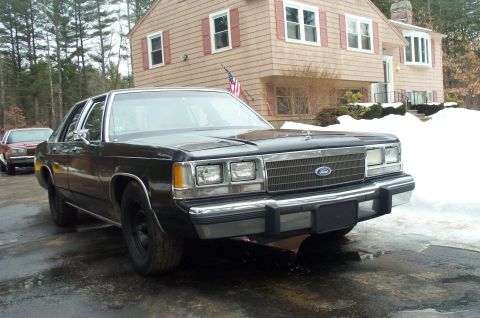 1991 Ford Crown Victoria LTD - A black 1991 Ford Crown Victoria LTD is parked in front of a house with snow on the ground.