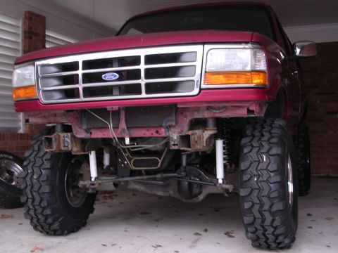 1995 Ford Bronco - Front view of a lifted 1995 Ford Bronco with large off-road tires and modified suspension.