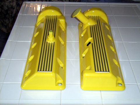 2002 Ford Mustang - A pair of yellow valve covers are displayed on a tiled surface.