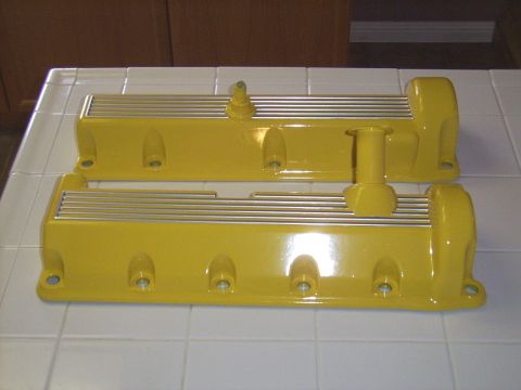 2002 Ford Mustang - Pair of yellow valve covers, likely aftermarket, shown on a tiled surface.