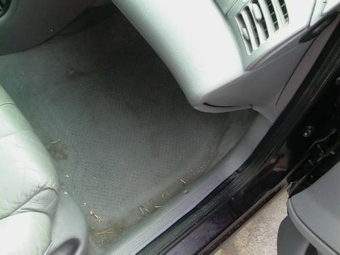 1995 Ford Contour - Passenger side interior floor and dashboard vent of a vehicle.