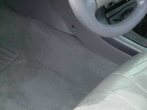 1995 Ford Contour - Interior view of a car, focusing on the floor and a portion of the steering wheel and seat.