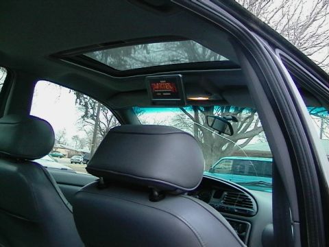 1995 Ford Contour - Interior view of a car's cabin, showing the sunroof, overhead screen, and seats.