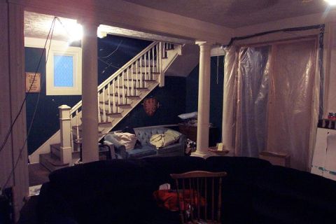 1985 Ford LTD Crown Victoria - Interior scene showing a staircase, furniture, and construction or renovation materials.