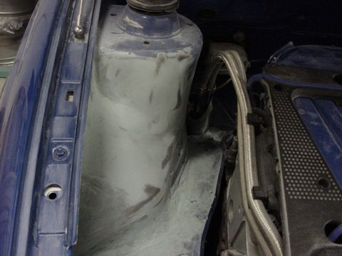 1998 Volkswagen Jetta - Detail of a car's engine bay, showing the strut tower and some engine parts.