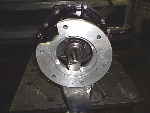 1984 Ford Bronco II - A vehicle transmission part is shown, held in a vise, with a splined shaft visible.