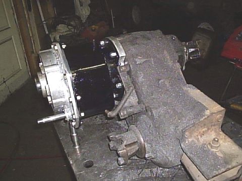 1984 Ford Bronco II - Transfer case assembly with visible bolted connections and a lever mechanism.