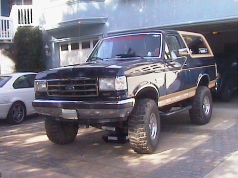 1991 Ford Bronco - This Ford Bronco has a two-tone paint job and large off-road tires.