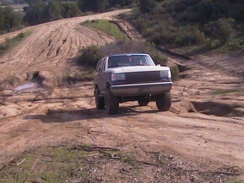 1991 Ford Bronco - A 1991 Ford Bronco navigates a rocky, off-road path.