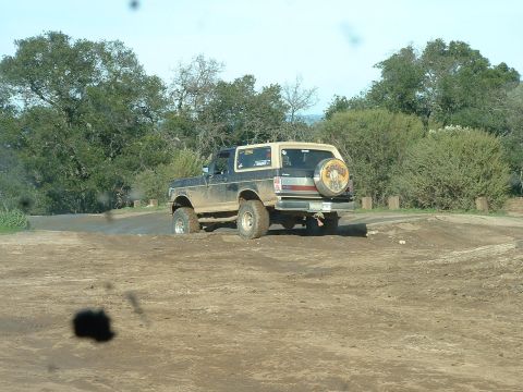 1991 Ford Bronco - 1991 Ford Bronco navigates a muddy off-road course.