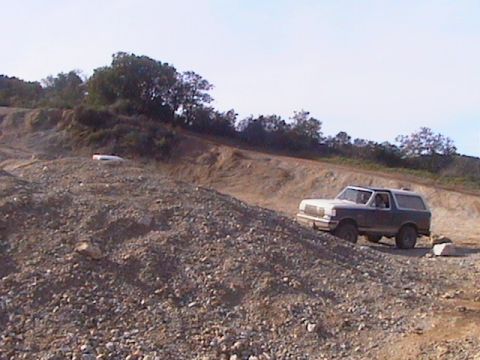 1991 Ford Bronco - Ford Bronco navigating a challenging off-road terrain.