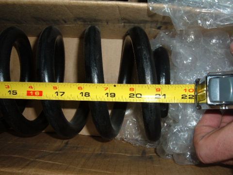 1993 Ford Bronco - Coil spring being measured with a tape measure, showing approximately 21 inches.