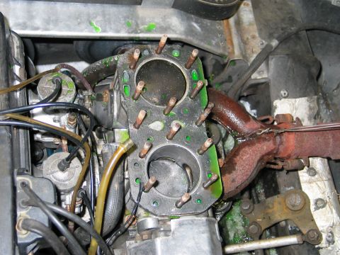 1990 Ford Mustang - Close-up of a snowmobile engine's cylinders, showing signs of coolant leakage.